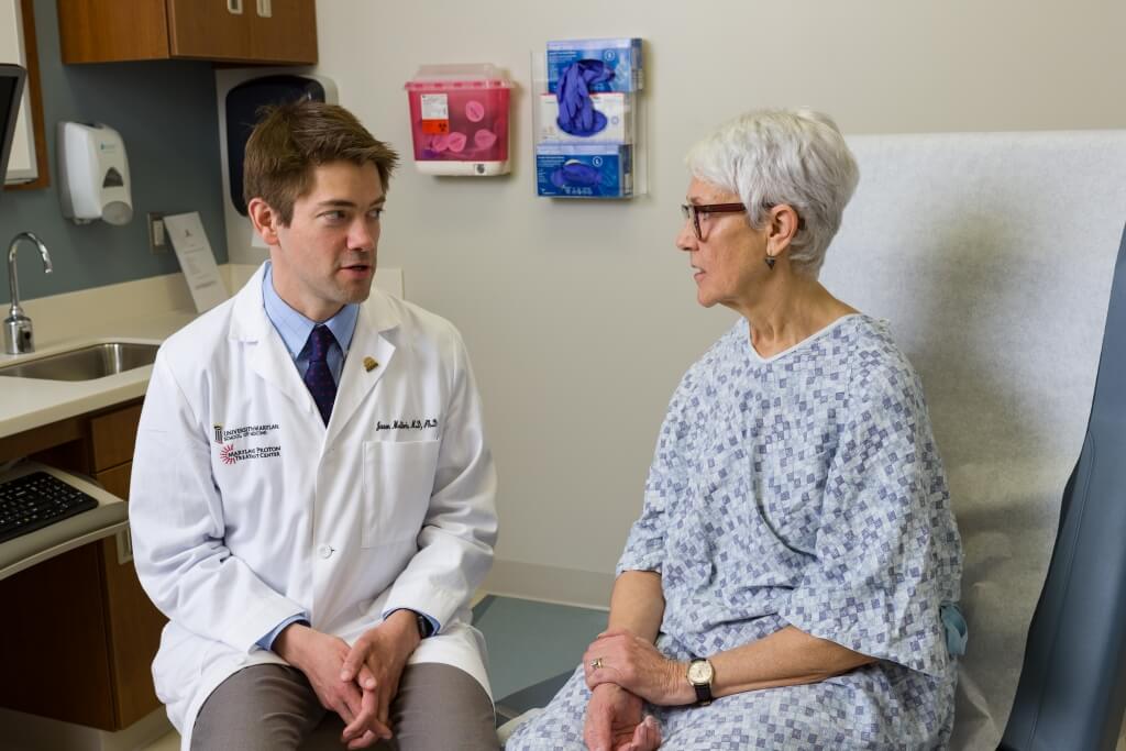 physician speaks with patient during appointment