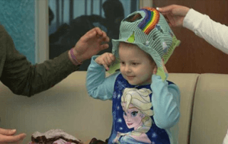 Hayden Haines, MPTC pediatric patient, puts on treatment mask