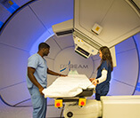 radiation therapists preparing for proton therapy treatment